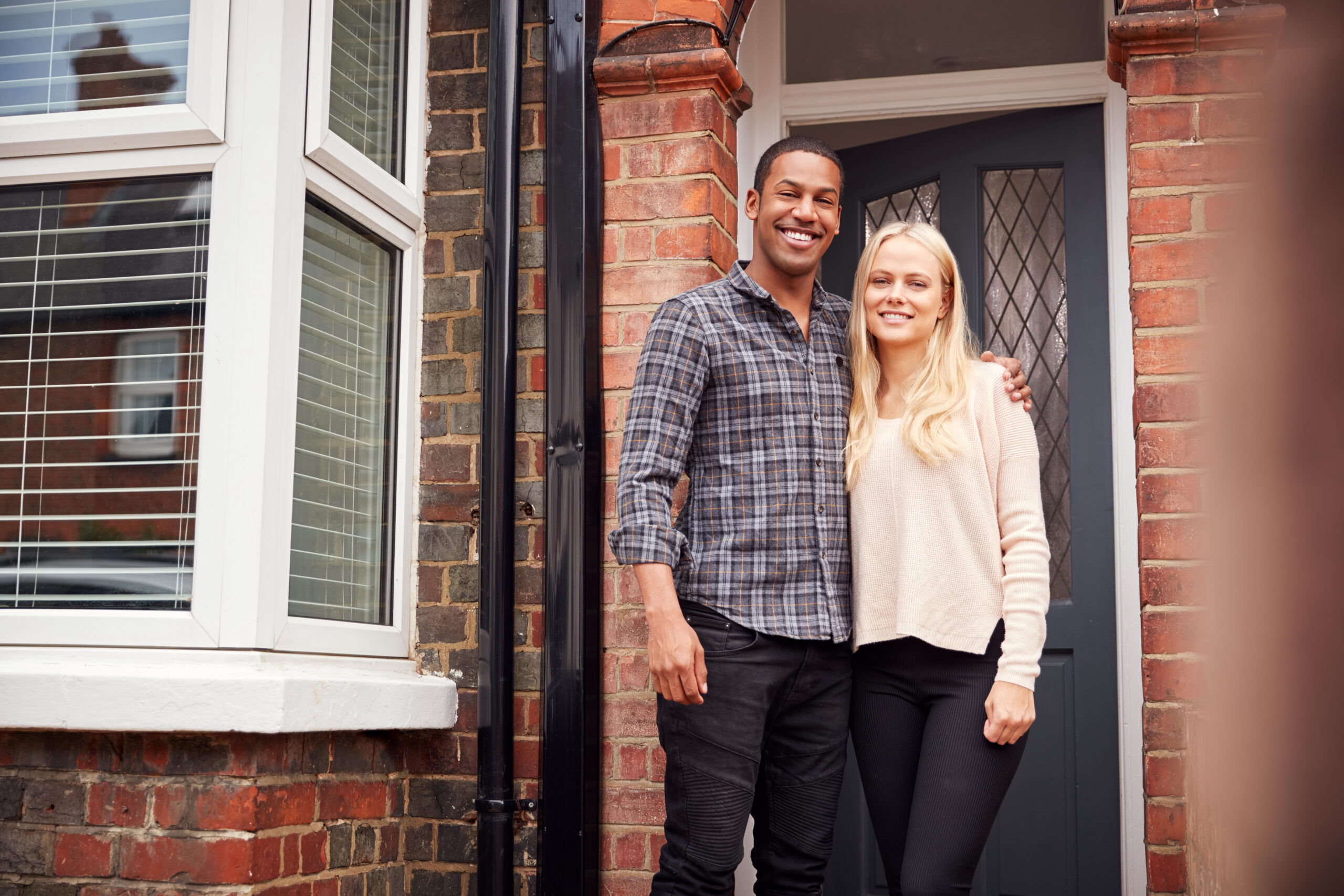 Portrait,Of,Proud,Young,Couple,Standing,Outside,First,Home,Together